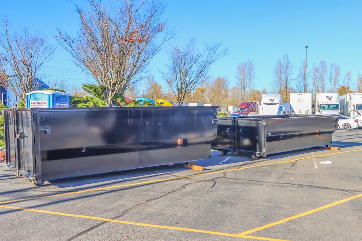 Professional dumpster rental service with roll-off container on residential driveway in La Crescent
